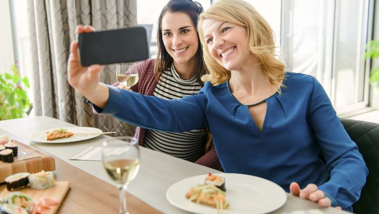 Women taking a selfie at lunch